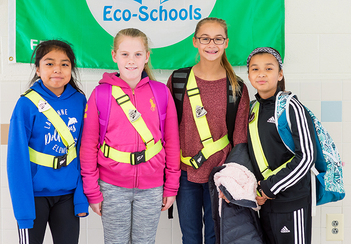 Photograph of four female students who are members of Lake Anne's Safety Patrol. The picture was taken in November 2018. 