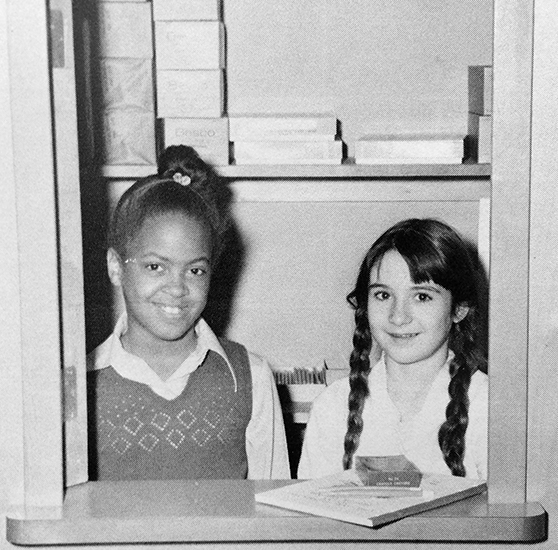 Black and white photograph, taken in 1974, showing two female students operating the school store. 