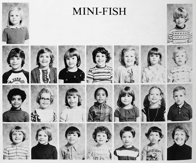Black and white photograph from our 1975 to 1976 yearbook showing some of the students grouped in Team Mini-Fish. 22 children and their teacher are pictured. 