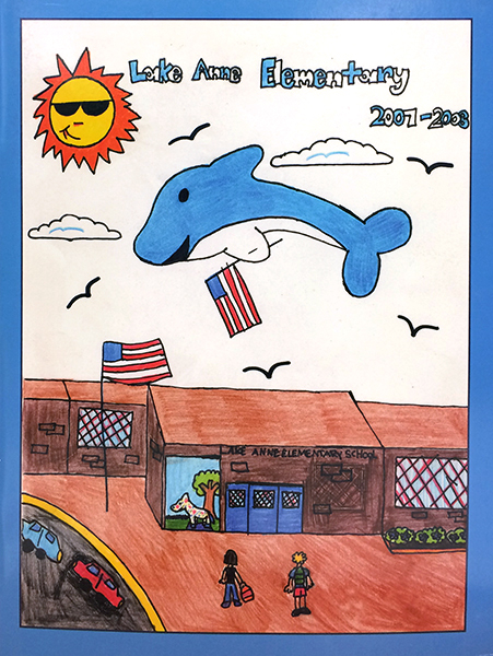 Photograph of Lake Anne's 2007 to 2008 yearbook cover. The cover is a student-drawn illustration of Lake Anne School with a dolphin leaping into the air above the building.